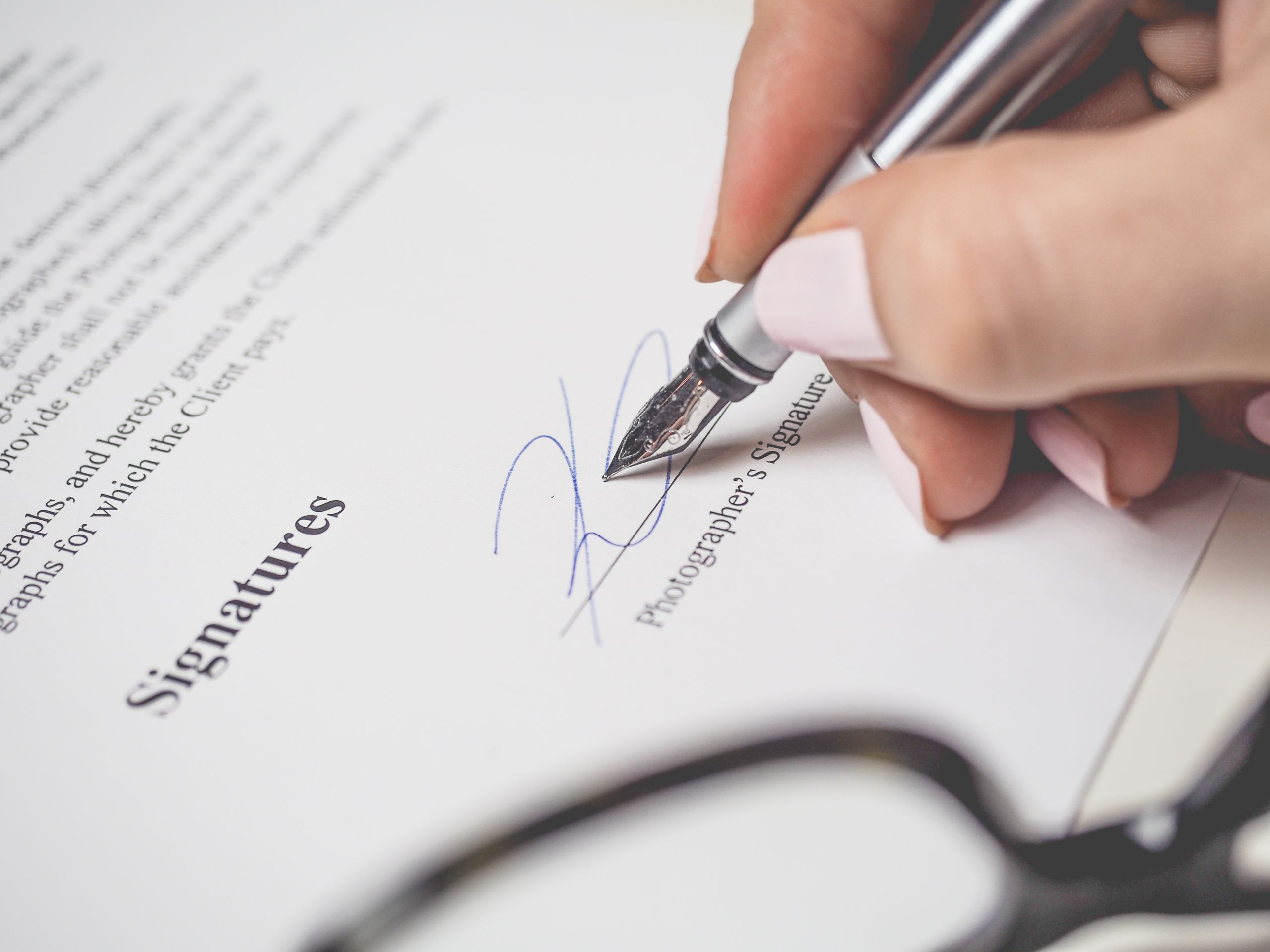 Person reviewing and signing a property document